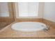 Bathroom features a soaking tub with tile surround and adjacent glass shower at 2008 Royal Gardens Pl, North Las Vegas, NV 89084