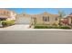 Charming single-story home featuring a two-car garage, desert landscaping, and a neutral color palette at 2008 Royal Gardens Pl, North Las Vegas, NV 89084