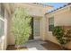 Close-up view of the front entrance highlighting the covered entry, desert plants, and modern front door at 2008 Royal Gardens Pl, North Las Vegas, NV 89084