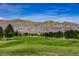 Scenic golf course view with lush green fairways and mountain backdrop at 2008 Royal Gardens Pl, North Las Vegas, NV 89084