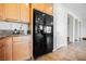 Spacious kitchen with black refrigerator and granite countertops at 2008 Royal Gardens Pl, North Las Vegas, NV 89084