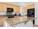 Close-up of kitchen island with granite countertop and stainless steel sink at 2008 Royal Gardens Pl, North Las Vegas, NV 89084