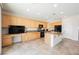 A gourmet kitchen with granite countertops, stainless steel appliances, and wooden cabinets at 2008 Royal Gardens Pl, North Las Vegas, NV 89084