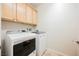Laundry room featuring a washer and dryer, as well as plenty of cabinet storage at 2008 Royal Gardens Pl, North Las Vegas, NV 89084