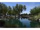 Still pond reflecting surrounding trees and landscaping, providing a serene outdoor space at 2008 Royal Gardens Pl, North Las Vegas, NV 89084
