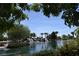 Picturesque lake scene with cascading waterfalls and mature palm trees on a sunny day at 2008 Royal Gardens Pl, North Las Vegas, NV 89084