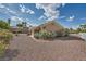 View of the backyard with low maintenance landscaping, mature trees, and privacy at 2401 Ocean Edge Ct, Las Vegas, NV 89134