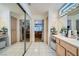 Bathroom with dual sinks, ample counter space, and access to the bedroom at 2401 Ocean Edge Ct, Las Vegas, NV 89134