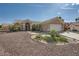 Single-story home with desert landscaping, tile roof, and two-car garage on a sunny day at 2401 Ocean Edge Ct, Las Vegas, NV 89134