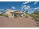Home exterior featuring a tile roof, desert landscaping, and mature trees at 2401 Ocean Edge Ct, Las Vegas, NV 89134