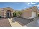 Well maintained desert landscape with tiled roof, pathway to a decorative secure front door and two-car garage at 2401 Ocean Edge Ct, Las Vegas, NV 89134