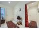 Bright foyer with white tile flooring, white front door and access to hallway at 2401 Ocean Edge Ct, Las Vegas, NV 89134