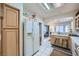 Functional kitchen with oak cabinets, white appliances, and lots of natural light at 2401 Ocean Edge Ct, Las Vegas, NV 89134