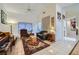 Well lit living room with tile flooring, piano, sofa and assorted furnishings at 2401 Ocean Edge Ct, Las Vegas, NV 89134