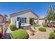 Relaxing backyard oasis featuring a hot tub, lush landscaping, and a charming covered patio at 2616 Red Planet St, Henderson, NV 89044