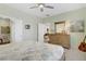 Bright bedroom with neutral walls, a ceiling fan, and doorways to the bathroom and living room at 2616 Red Planet St, Henderson, NV 89044