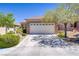 Charming single-story home with a two-car garage, desert landscaping, and a beautiful stone facade at 2616 Red Planet St, Henderson, NV 89044