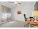Bright office space with a ceiling fan, artwork, and a comfortable desk area at 2616 Red Planet St, Henderson, NV 89044