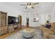 Spacious living room with a large screen TV, rustic wood furnishings, and an eye-catching patterned rug at 2616 Red Planet St, Henderson, NV 89044