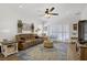 Inviting living room featuring a ceiling fan, plush sofa, area rug, and sliding glass door at 2616 Red Planet St, Henderson, NV 89044