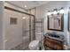 Modern bathroom with tiled walk-in shower featuring a glass enclosure, and a vanity with decorative mirror at 2708 Beaver Creek Ct # 202, Las Vegas, NV 89117