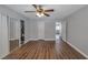 Spacious bedroom with a ceiling fan, laminate flooring, a mirrored sliding-door closet, and an open entry at 2708 Beaver Creek Ct # 202, Las Vegas, NV 89117