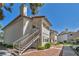 Two-story condo building with exterior stairs and desert landscaping on a sunny day at 2708 Beaver Creek Ct # 202, Las Vegas, NV 89117