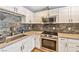 Stylish kitchen featuring white cabinets and stainless steel appliances at 2708 Beaver Creek Ct # 202, Las Vegas, NV 89117