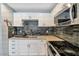 Modern kitchen with stainless appliances and stone backsplash at 2708 Beaver Creek Ct # 202, Las Vegas, NV 89117