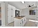 Modern kitchen featuring white cabinets, granite countertops, stainless steel appliances, and a center island cooktop at 2714 Bridgepointe Dr, Las Vegas, NV 89121