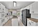 Stylish kitchen with white cabinets, granite countertops, and stainless-steel appliances at 2714 Bridgepointe Dr, Las Vegas, NV 89121
