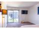 Bright bedroom featuring sliding glass doors to a patio area, and a wall-mounted TV at 3030 Liberty Cir, Las Vegas, NV 89121