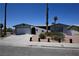 Charming single-story home with a front yard, wide driveway, and an attached garage at 3030 Liberty Cir, Las Vegas, NV 89121