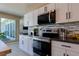 Modern kitchen featuring stainless steel appliances, sleek white cabinetry, and stylish backsplash at 3030 Liberty Cir, Las Vegas, NV 89121