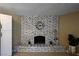 Cozy living room with a decorative brick fireplace and tiled hearth, perfect for relaxation and comfort at 3030 Liberty Cir, Las Vegas, NV 89121