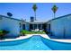 Inviting swimming pool area with lounge chairs, lush greenery, and tall palm trees creating a backyard oasis at 3030 Liberty Cir, Las Vegas, NV 89121