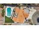 Aerial view of the private backyard, showcasing the uniquely shaped pool and attached spa with desert landscaping at 3421 Rochelle Ct, Las Vegas, NV 89121