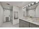 Contemporary bathroom with marble countertops, double sinks, and a glass-enclosed shower/tub combo at 3421 Rochelle Ct, Las Vegas, NV 89121