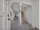 Inviting entryway featuring an arched doorway, staircase, and access to multiple rooms with natural light at 3421 Rochelle Ct, Las Vegas, NV 89121