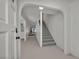 Inviting foyer with staircase, neutral carpet, and open view to the living area at 3421 Rochelle Ct, Las Vegas, NV 89121