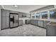 Bright kitchen featuring stainless steel appliances, gray cabinets, and large window at 3421 Rochelle Ct, Las Vegas, NV 89121