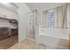 Bright bathroom showcasing a soaking tub and a walk-in shower behind glass doors at 3561 Yorba Linda Dr, Las Vegas, NV 89122