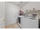 Laundry room with modern washer and dryer, storage shelf and tile floors at 3561 Yorba Linda Dr, Las Vegas, NV 89122