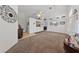 Spacious living room with neutral carpet, tile accents, and decorative wall decor at 3561 Yorba Linda Dr, Las Vegas, NV 89122