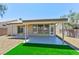 Home's rear facade has a covered patio and large windows, with low maintenance gravel landscaping and artificial turf at 3622 Covewick Dr, North Las Vegas, NV 89032