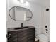 Stylish bathroom featuring decorative vanity, black fixtures, and shower-tub combo at 3622 Covewick Dr, North Las Vegas, NV 89032