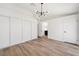 Bright bedroom featuring hardwood flooring, modern lighting, and closet space at 3622 Covewick Dr, North Las Vegas, NV 89032