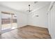 Bright bedroom features wood-look floors, vaulted ceiling, modern light fixture, and sliding door to backyard at 3622 Covewick Dr, North Las Vegas, NV 89032