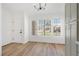 Cozy living room with wood floors, three large picture windows, and modern lighting at 3622 Covewick Dr, North Las Vegas, NV 89032