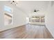 Bright living room featuring hardwood flooring, modern lighting, and large windows at 3622 Covewick Dr, North Las Vegas, NV 89032